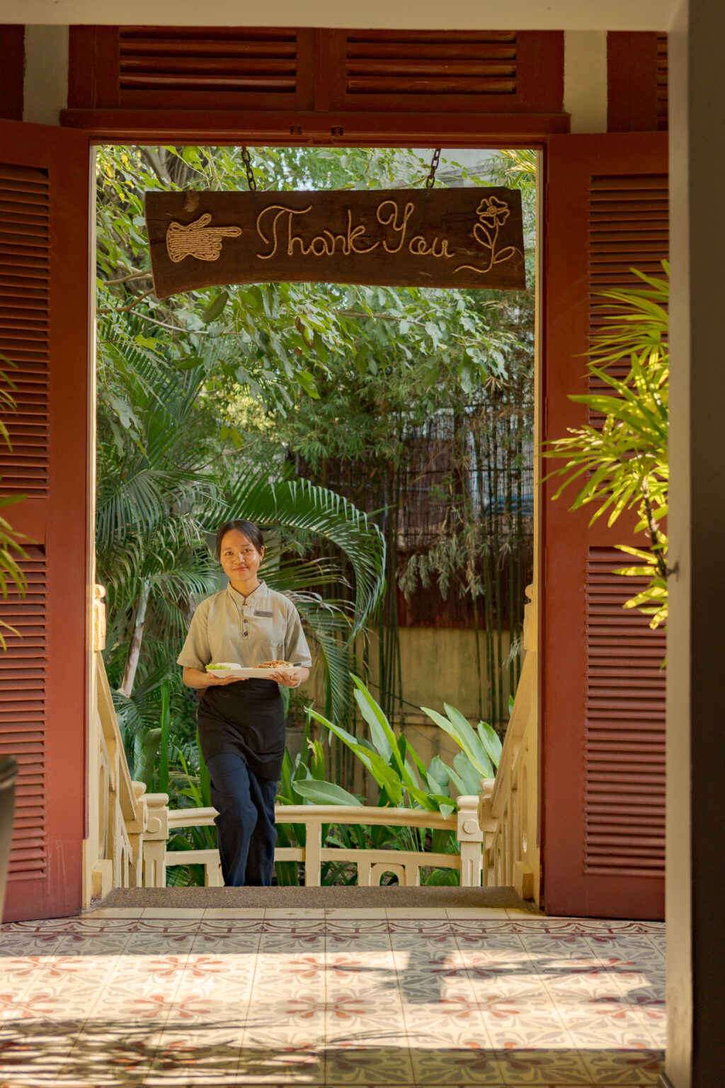 staff at areca restaurant holding food